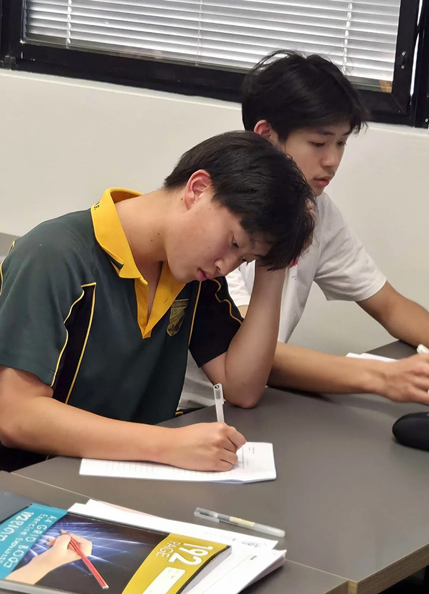 A BEAM student working through a problem with help alongside