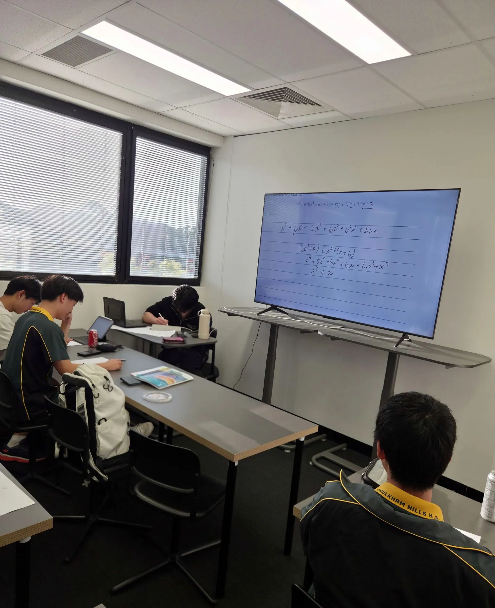 The BEAM Academy classroom in Epping, a question on the screen and students at work