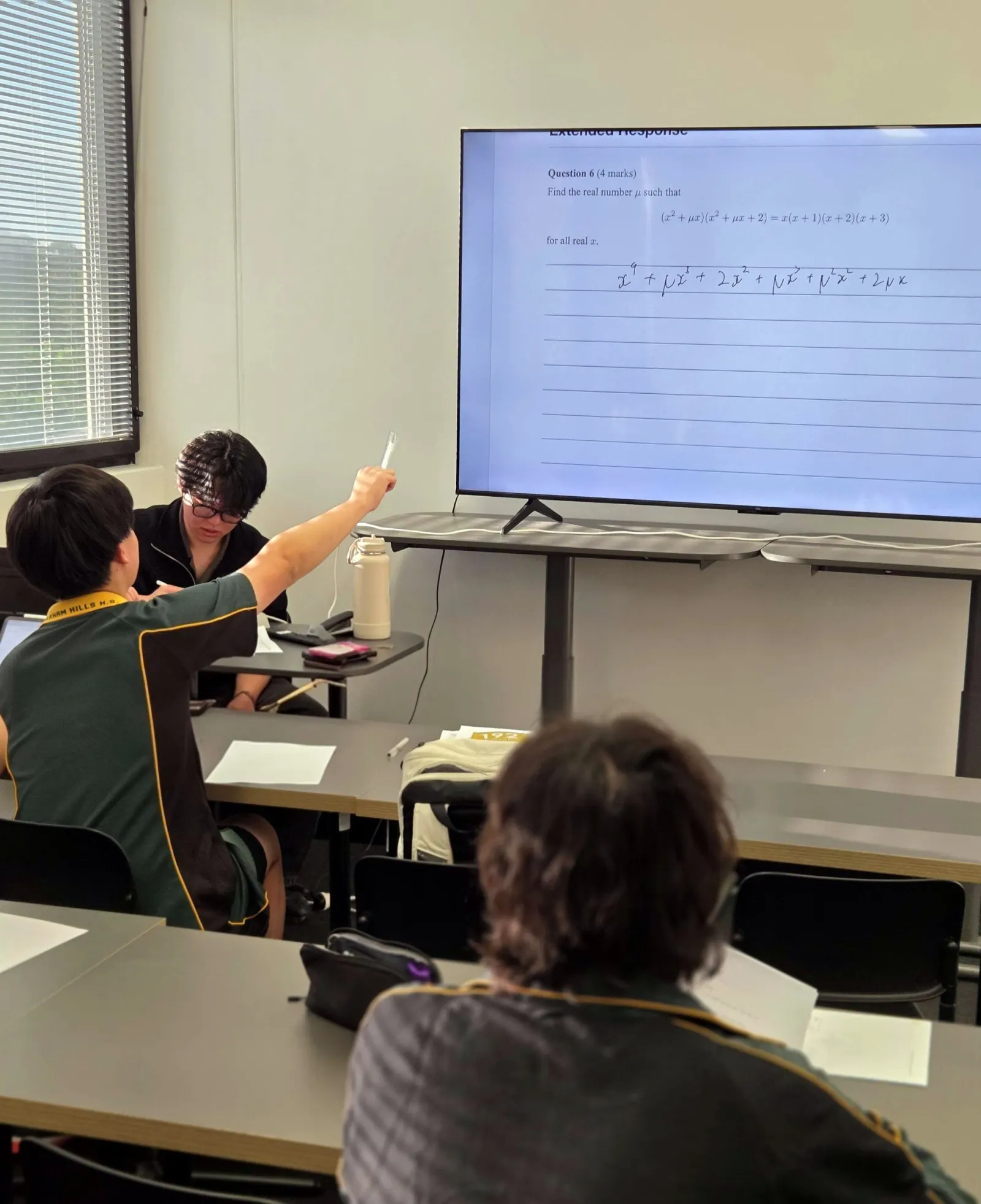 A student answering a question at the classroom screen