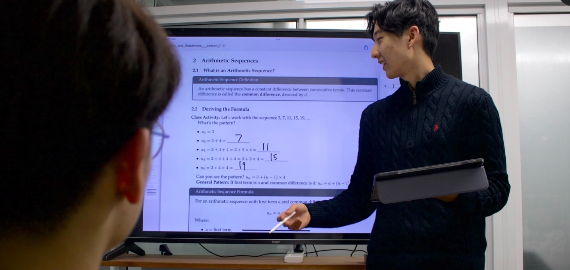 BEAM tutor teaching at whiteboard